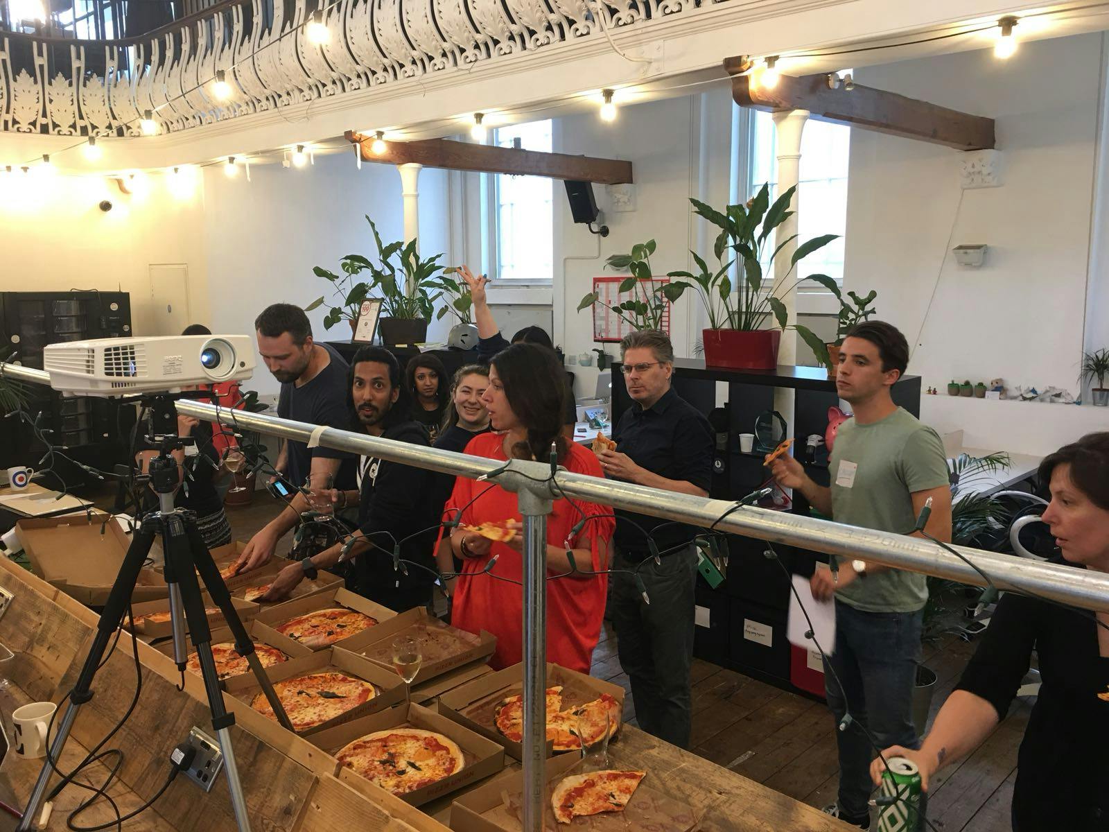 Casual networking event at Launch22 King's Cross with attendees enjoying pizza and drinks.