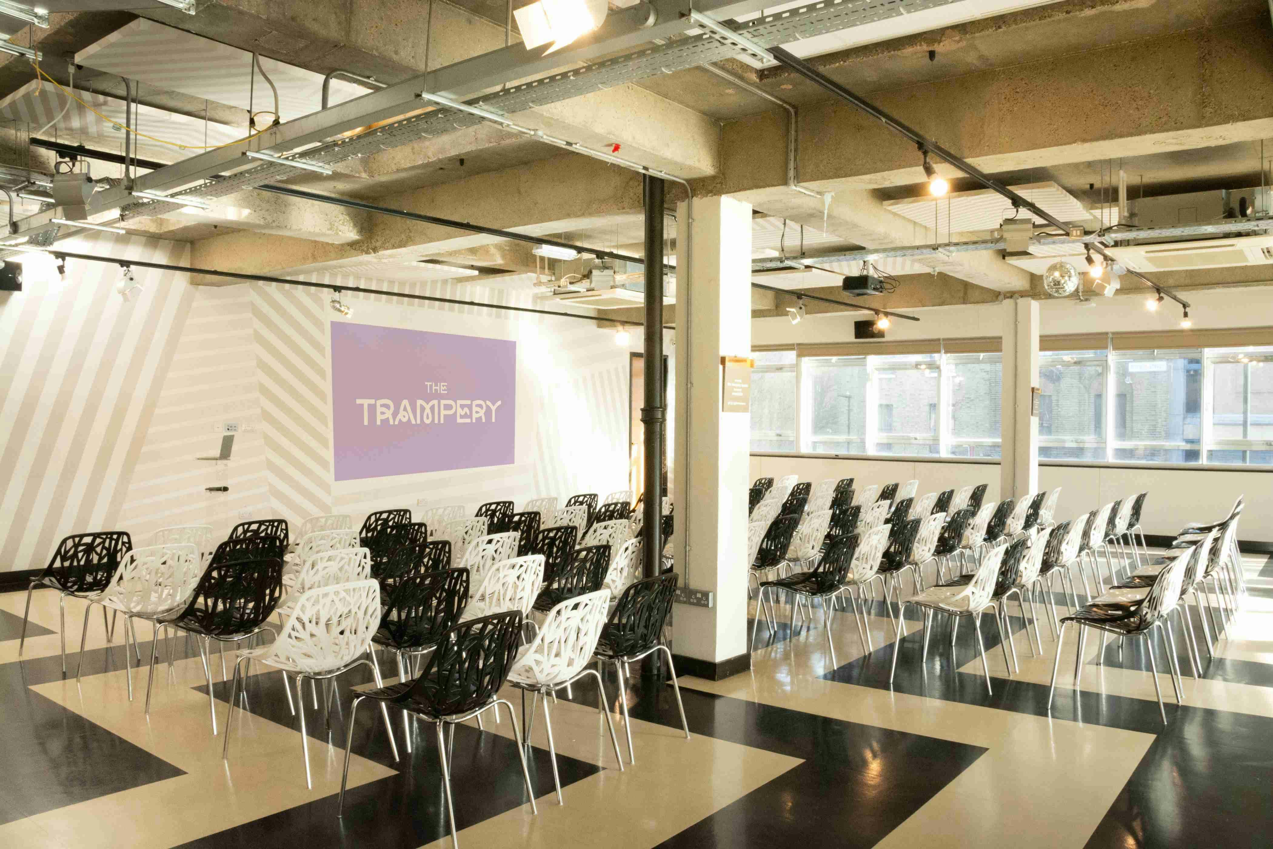 Modern event space with stylish chairs, ideal for presentations and workshops.