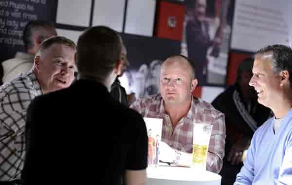 Champions Lounge at Liverpool FC, professionals networking over drinks in a relaxed setting.