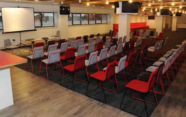 Champions Lounge at Liverpool FC, modern meeting space with projector for workshops.