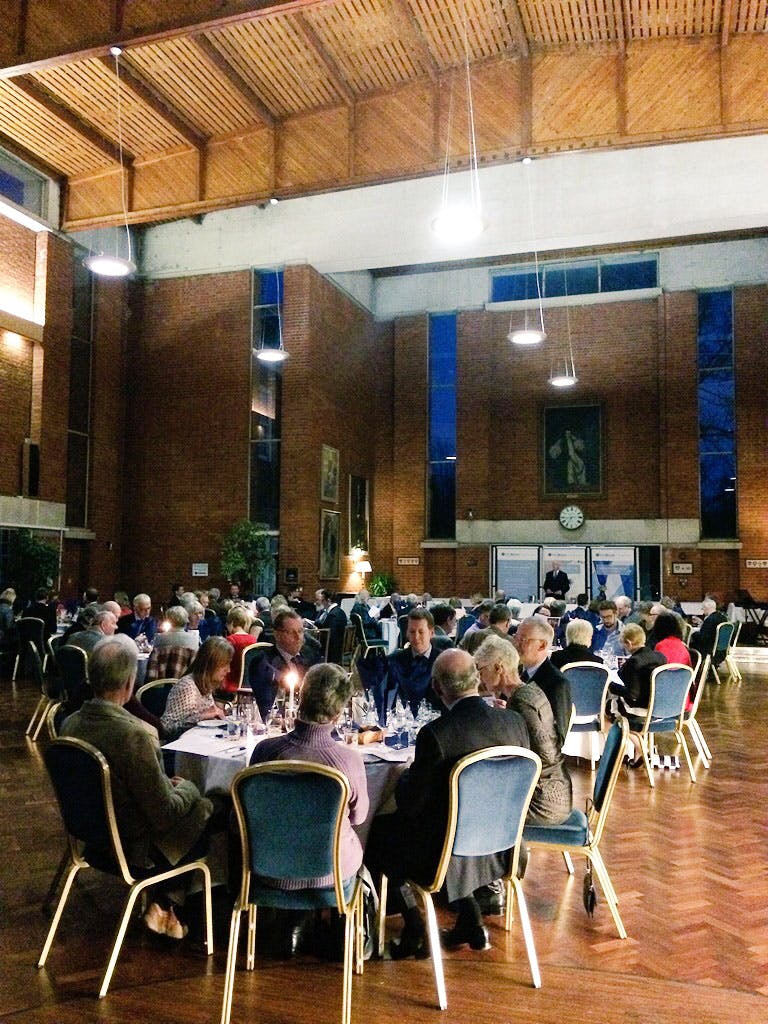 Norwood Hall event with round tables, warm lighting for networking and engagement.