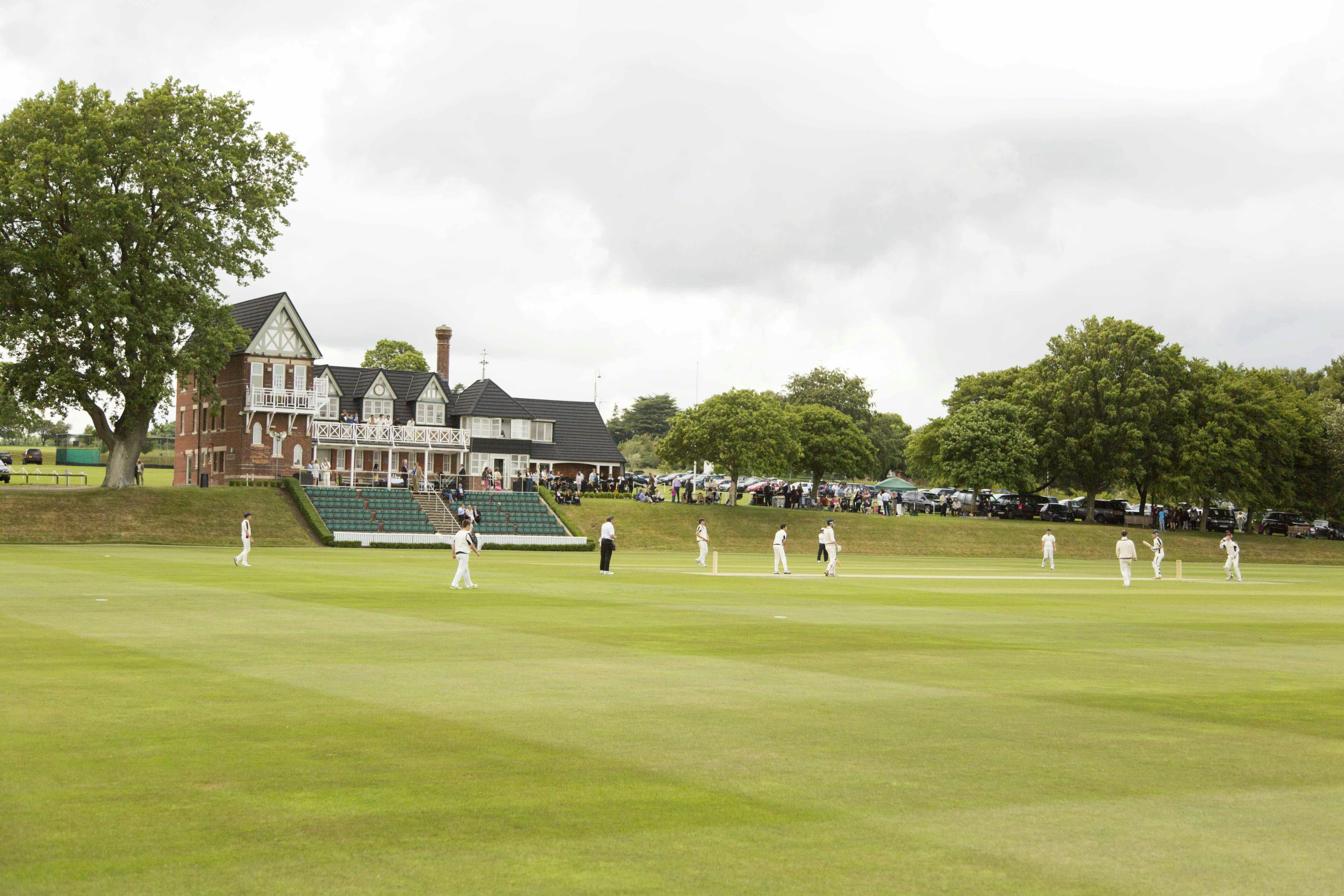 Cricket Pavilion at Marlborough College, lush green field for outdoor events and gatherings.