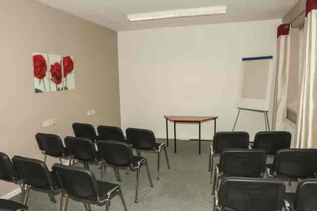 Briton Room in Ayton House: simple meeting space with black chairs for workshops.