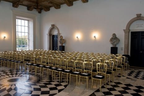 Elegant gold chairs in The Great Hall, perfect for upscale events and conferences.