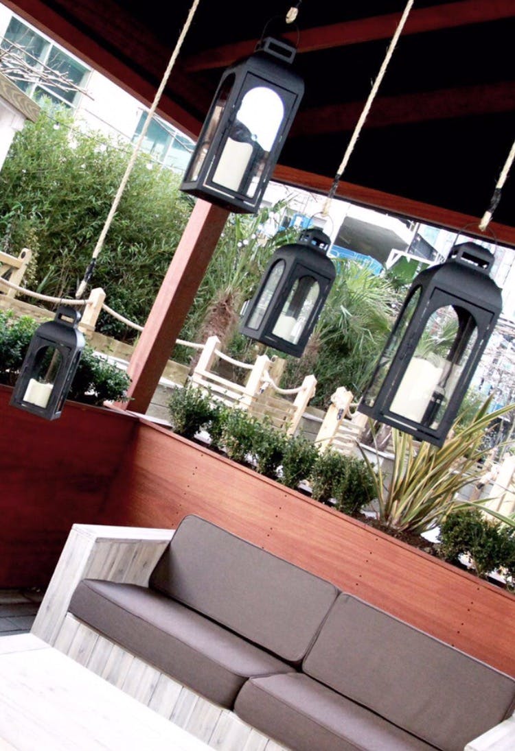 Charming outdoor restaurant terrace with stylish lanterns for evening events.
