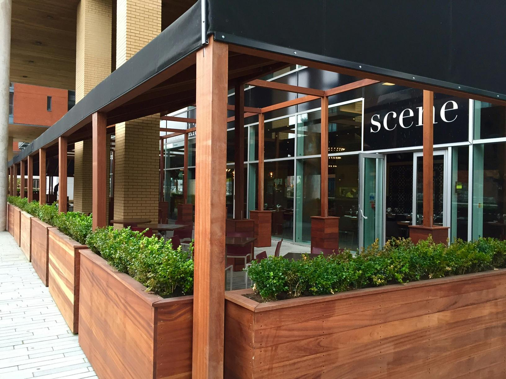 Stylish outdoor restaurant terrace with wooden structures, perfect for social events.