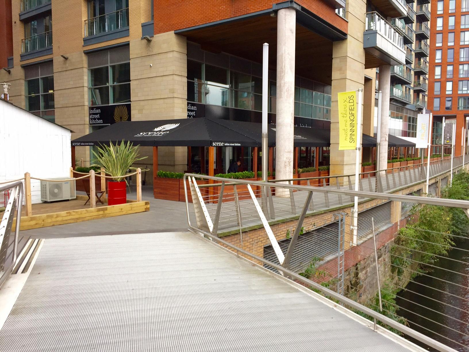 Modern riverside restaurant with outdoor seating, perfect for events and gatherings.