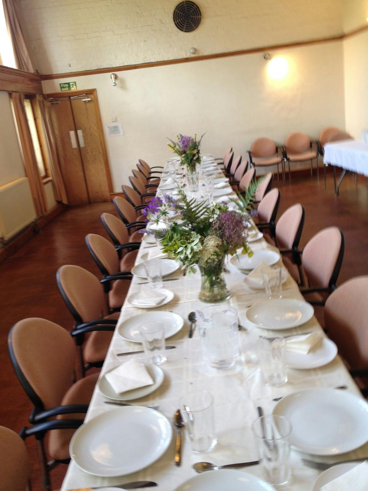 Elegant dining table with floral centerpieces for a formal event at Inner Wealth Retreat.