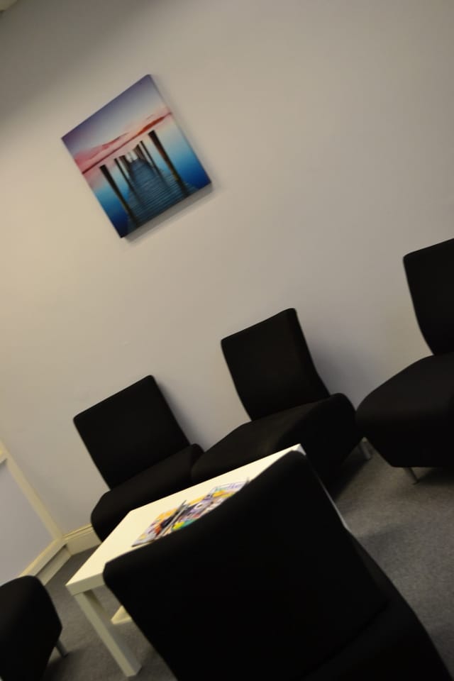 Minimalist meeting space with sleek black chairs for informal discussions and brainstorming.