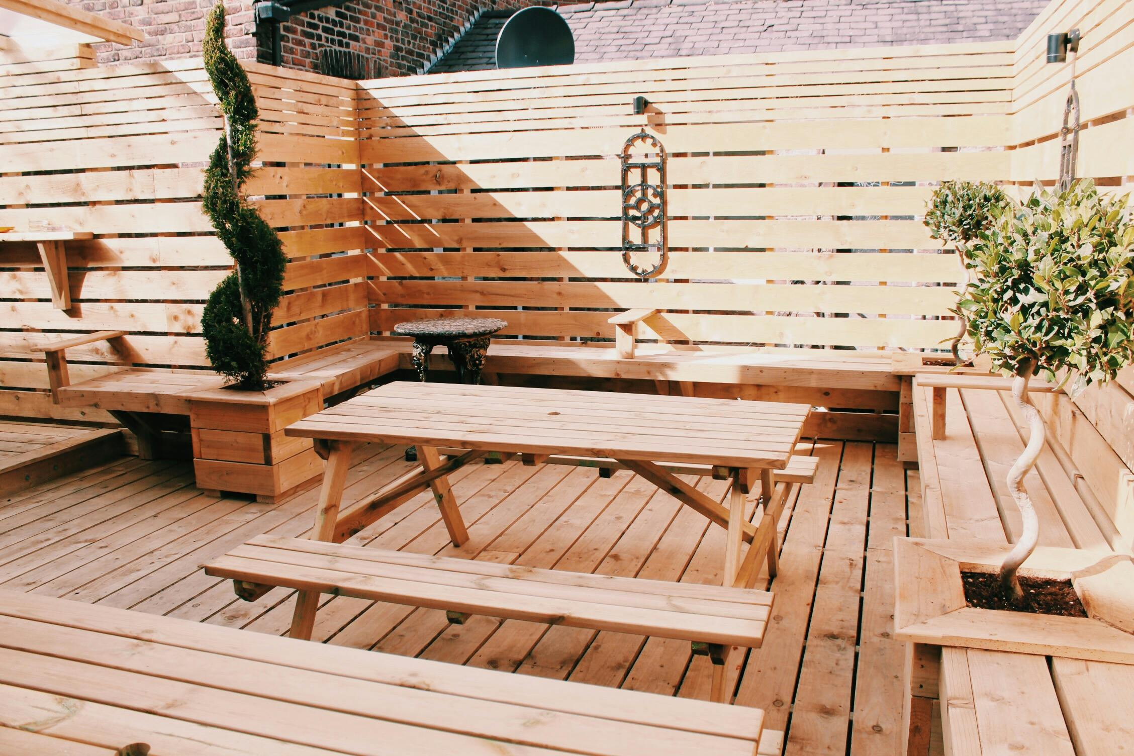 Versatile outdoor venue with wooden seating for casual meetings and networking events.