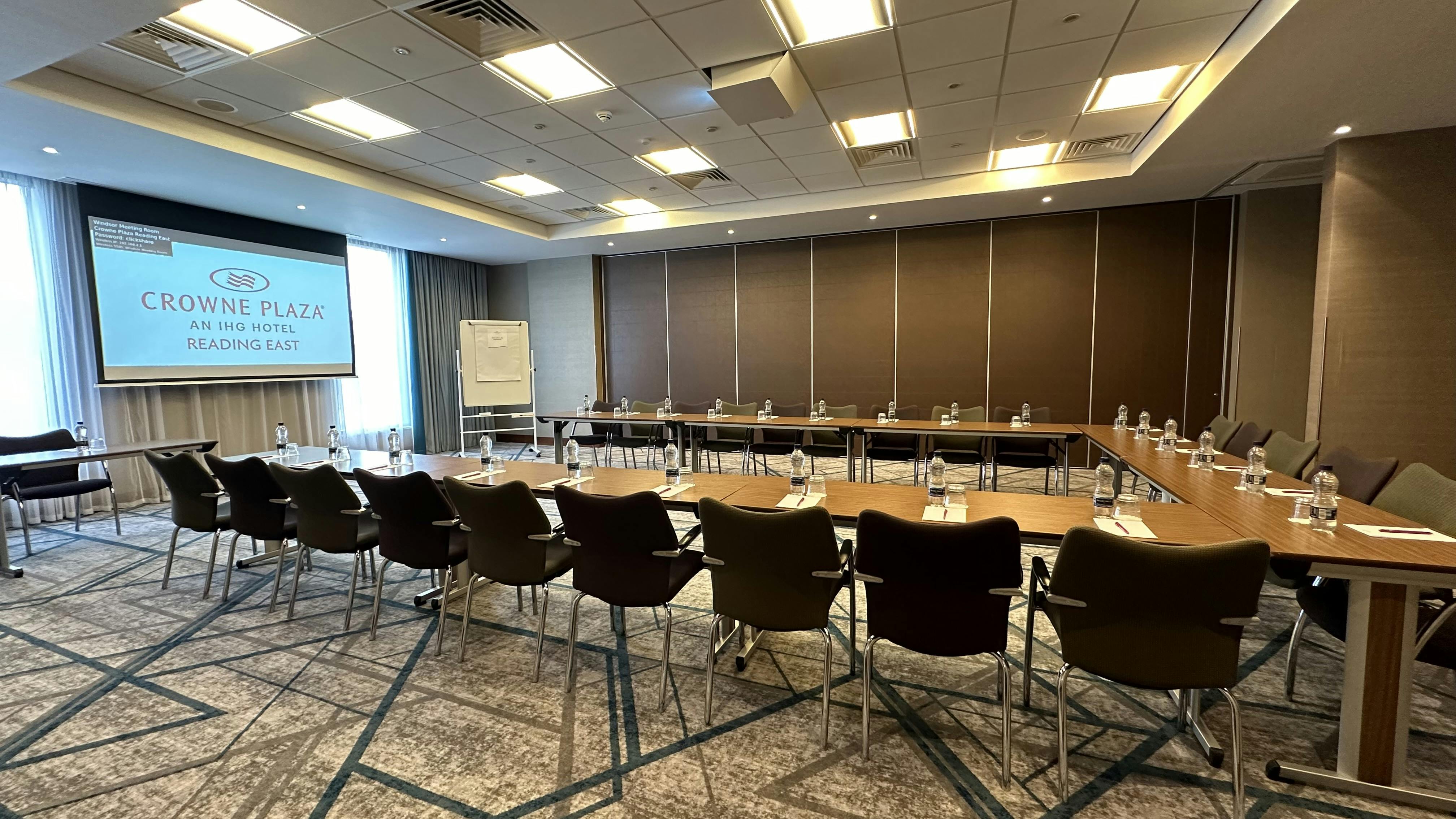 Meeting room at Crowne Plaza Reading East with large screen for corporate events.