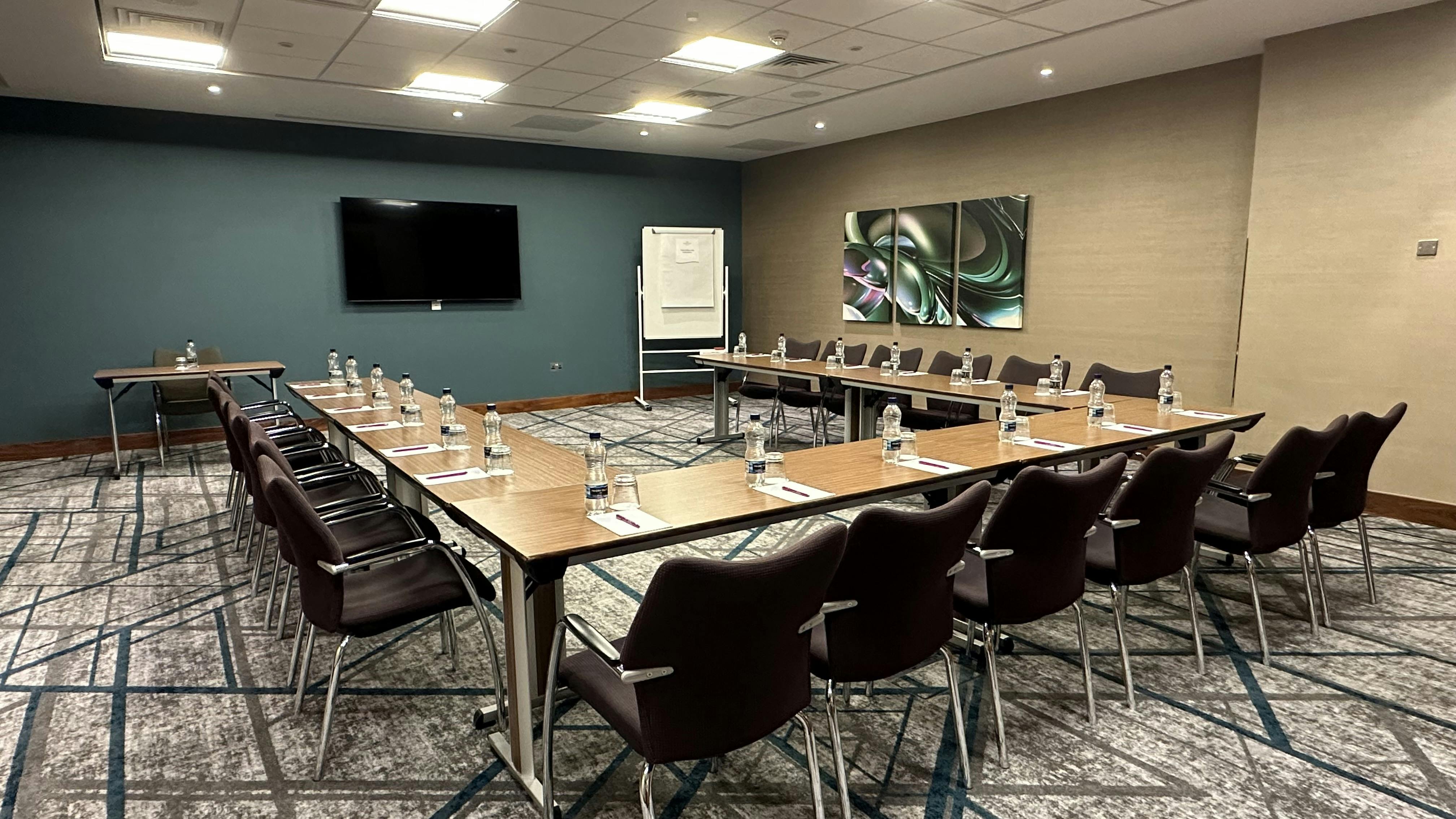 Marlow meeting room with large table, modern decor for professional events and gatherings.