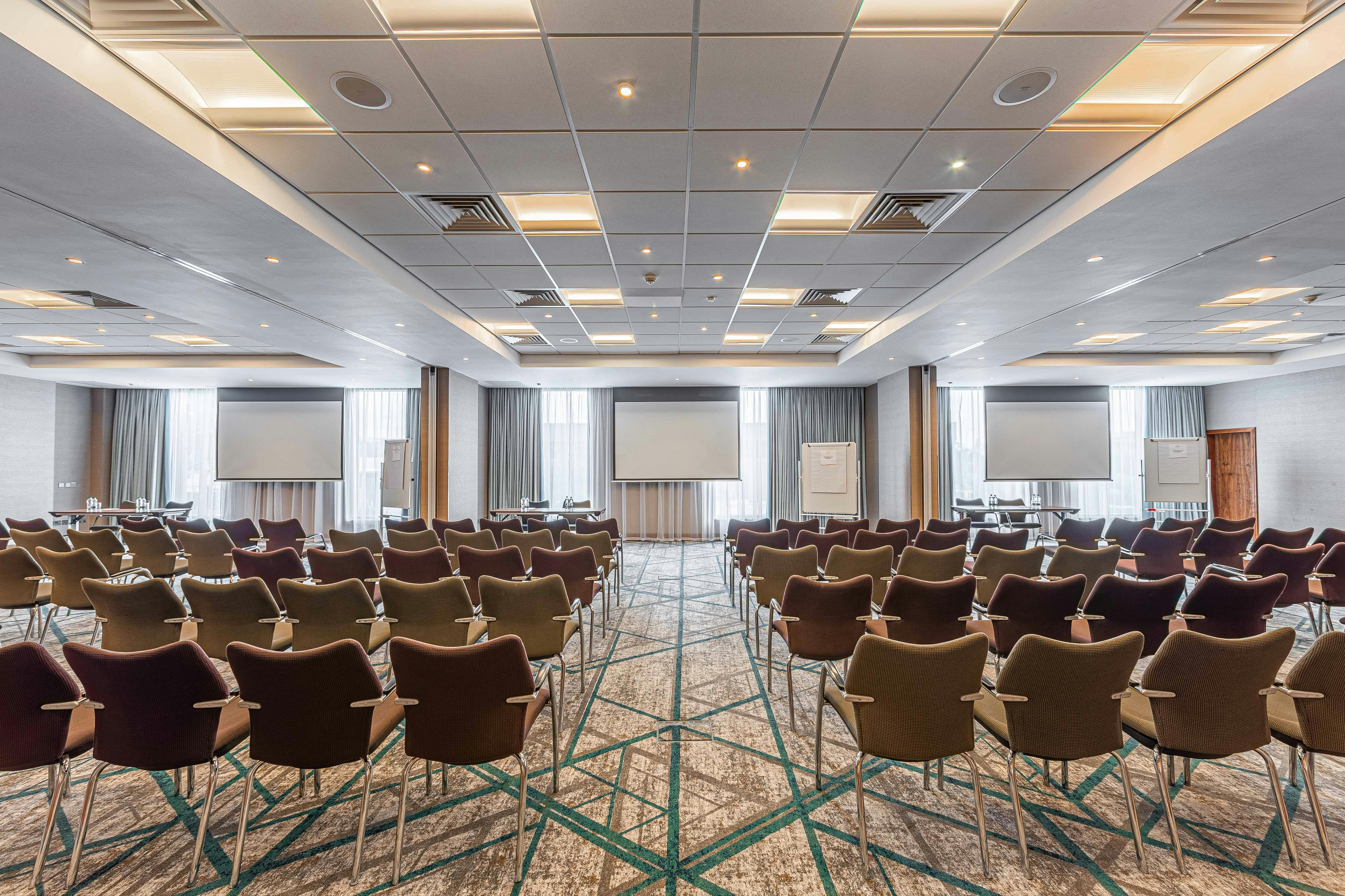 Conference room at Crowne Plaza Reading East with comfortable chairs and natural light.