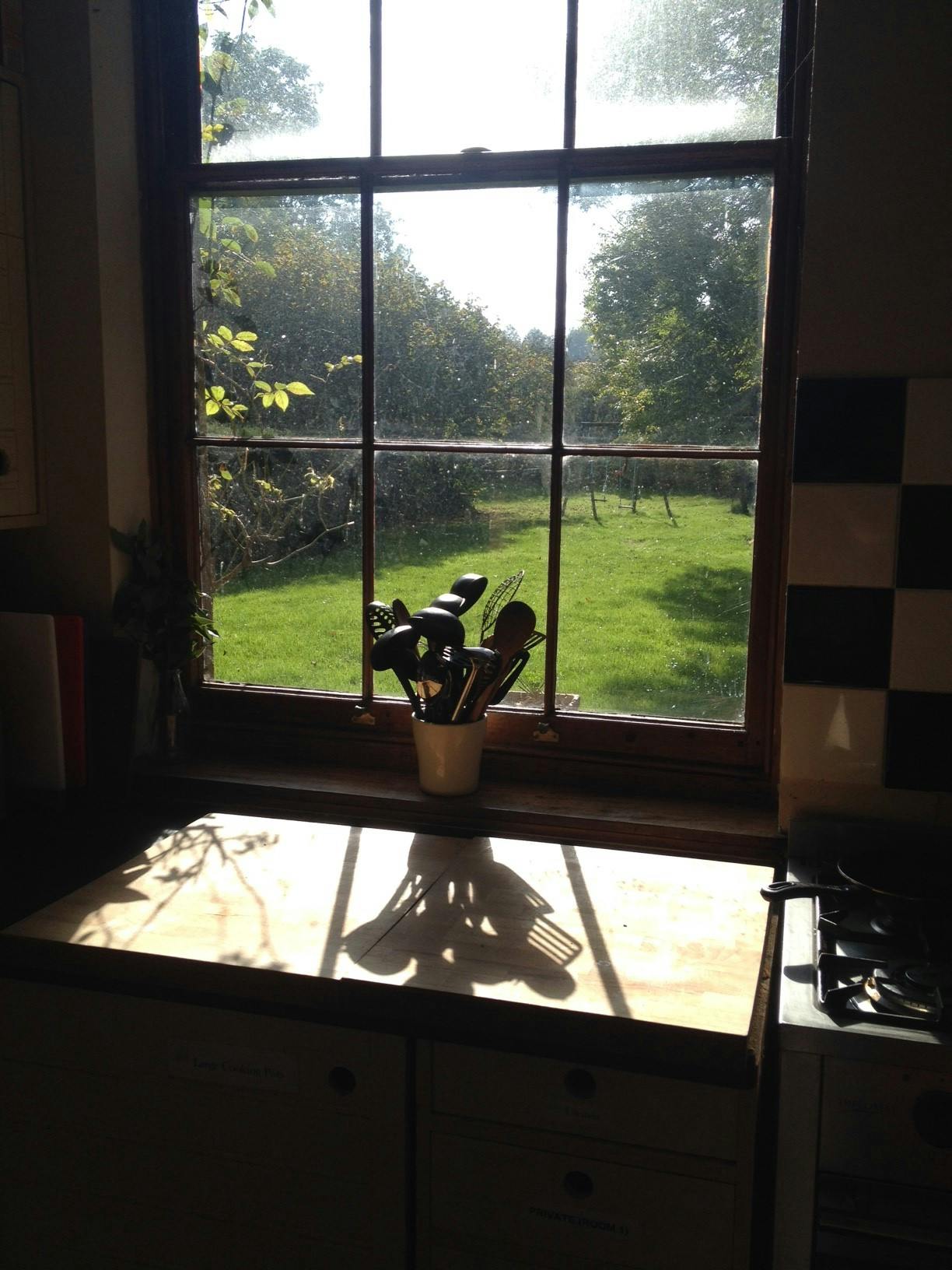 Serene farmhouse kitchen with natural light, perfect for culinary workshops and retreats.