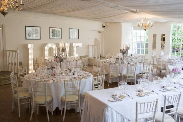 Elegant Banqueting Hall with floral centerpieces for weddings and romantic events.