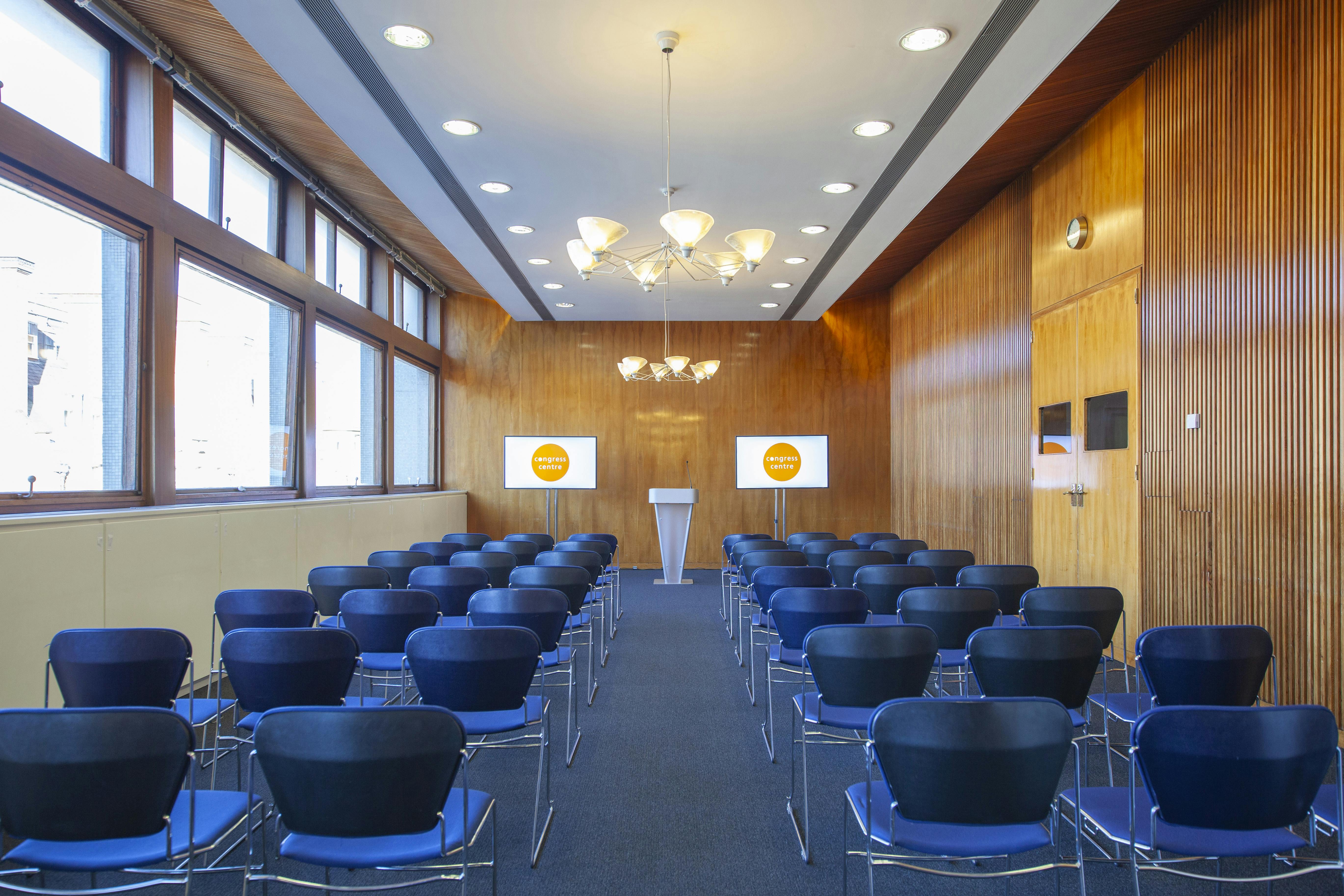 "Meeting Rooms 1-4 in Congress Centre, featuring rows of chairs for corporate seminars."