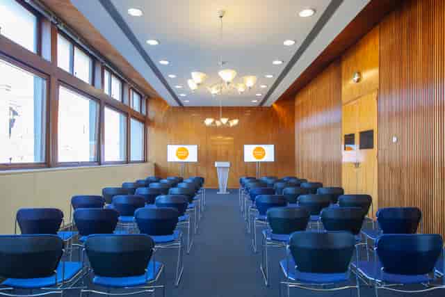 "Meeting Rooms 1-4 in Congress Centre, featuring rows of chairs for corporate seminars."