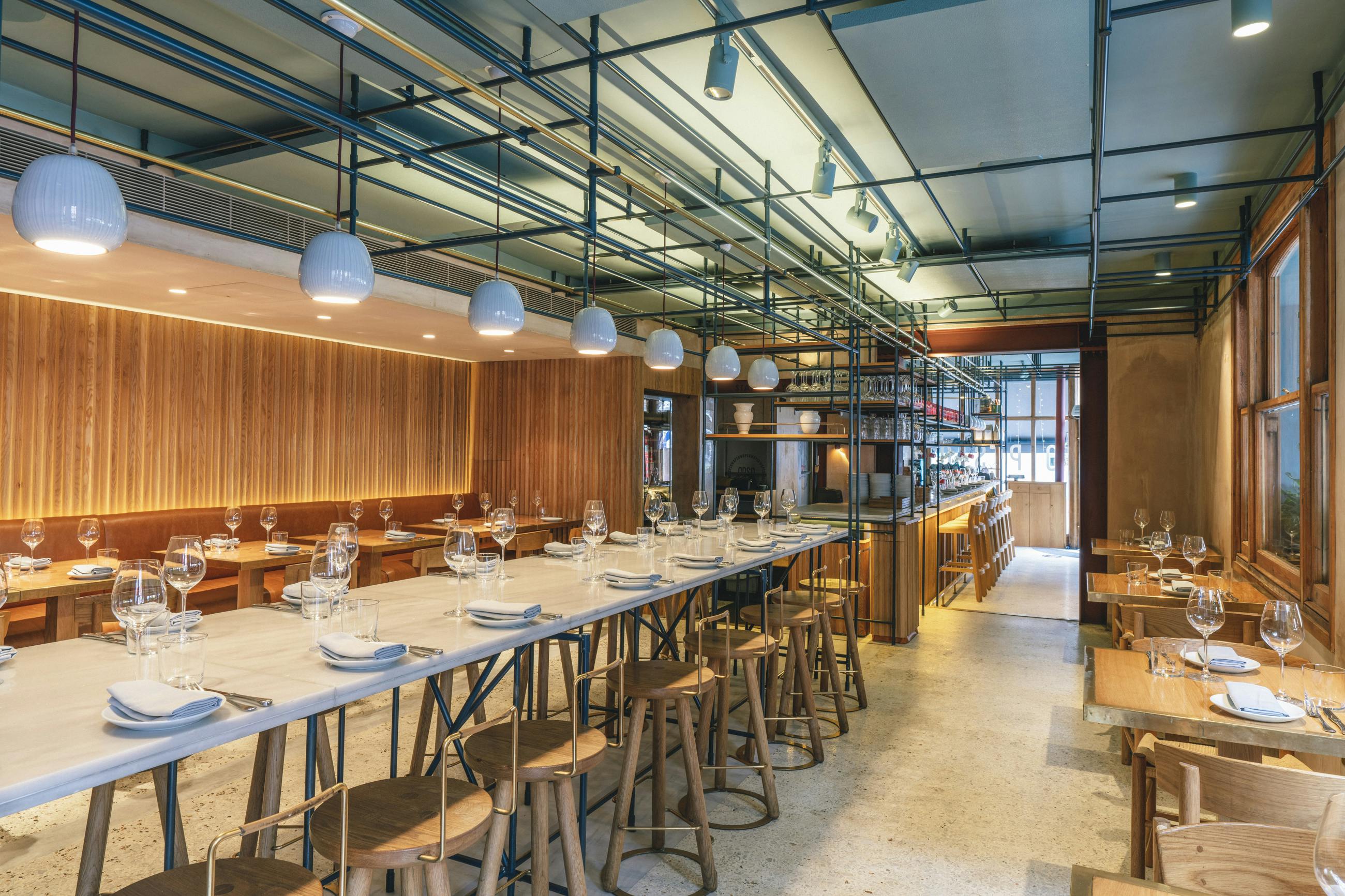 Modern dining room at OPSO with communal table for events and meetings.