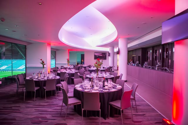 Allianz Stadium Members' Lounge set for a formal dinner with elegant table settings.