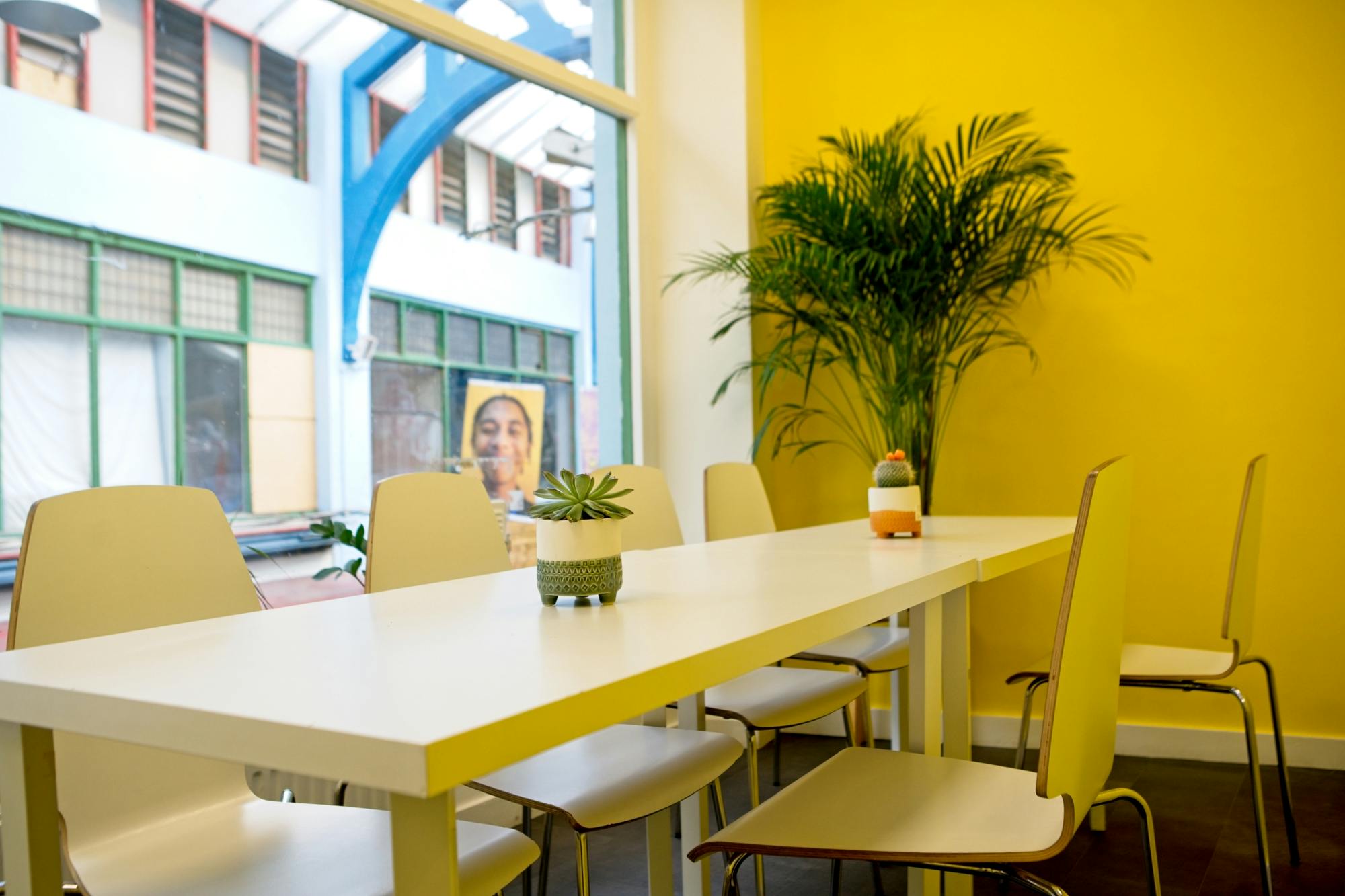 Bright meeting space in Impact Brixton with a long white table, ideal for workshops.