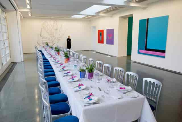 Elegant boardroom table and silver chairs at a Serpentine Galleries corporate dinner or event.