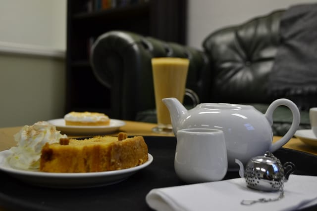 Cozy meeting space with teapot, pastries for networking at Flavours & Fables.