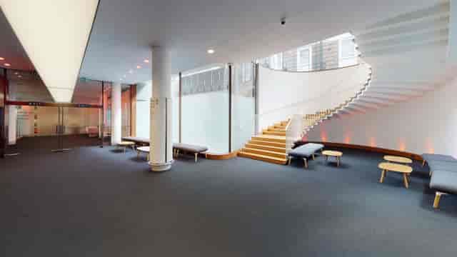 Modern Congress Centre foyer with sleek staircase, ideal for networking events and workshops.