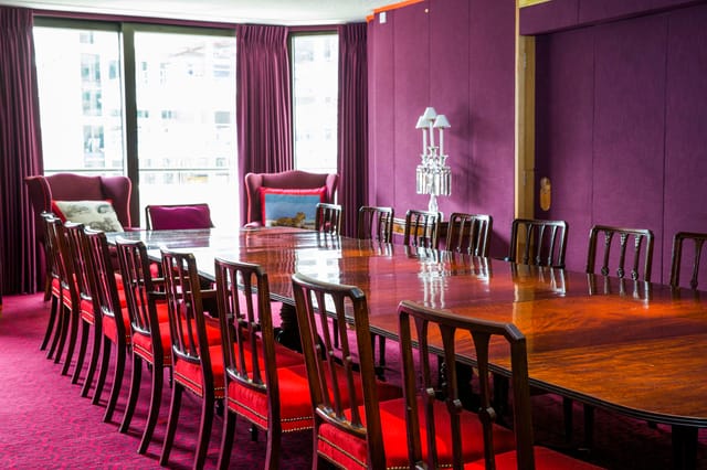 Elegant meeting room with polished table, ideal for discussions and events.
