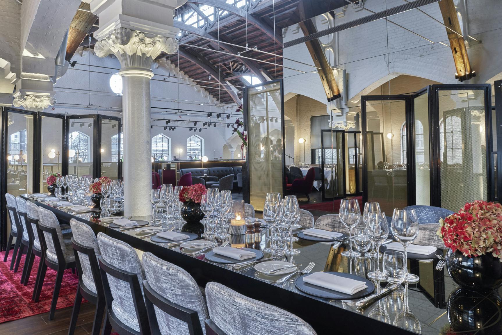 Semi-private event space in German Gymnasium with elegant dining setup and floral decor.