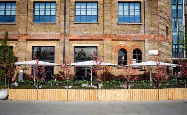 Charming outdoor venue at German Gymnasium with modern canopies for events and gatherings.