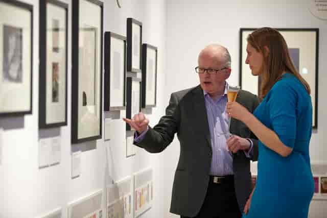 Networking event at Bankside Gallery with attendees in formal attire and artwork.