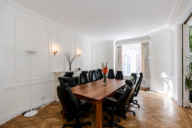 Boutique Boardroom with large wooden table, ideal for meetings and brainstorming sessions.
