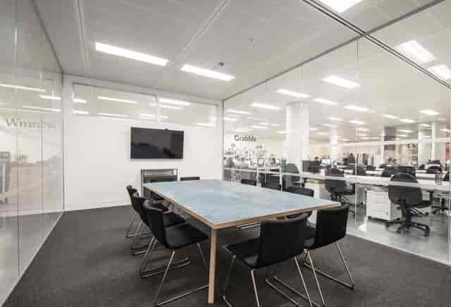 Howard Hughes minimalist breakout room for agile team meetings and professional client briefings.