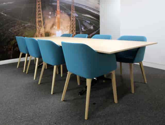 Buzz Aldrin in a minimalist 8-person breakout session setup for corporate workshops and meetings.