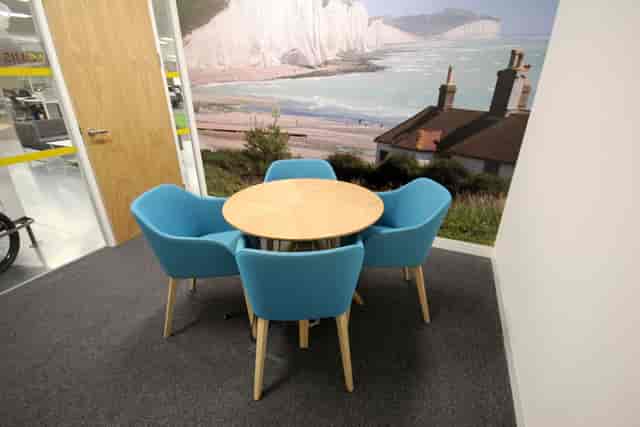 Louis Bleriot huddle room with round table for collaborative corporate breakout meetings.