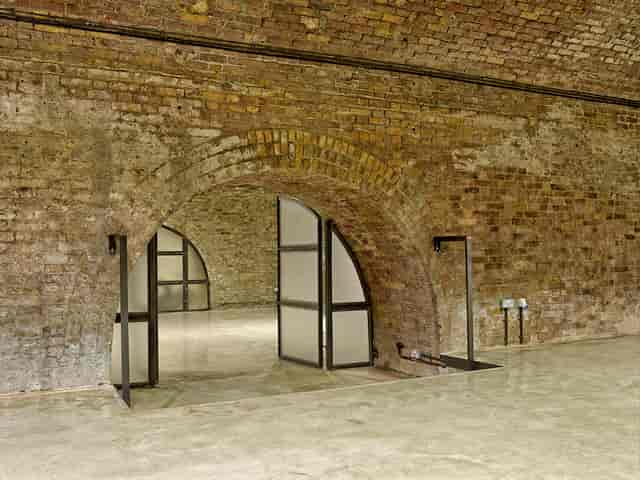 Versatile event space with exposed brick walls, ideal for gatherings and meetings.