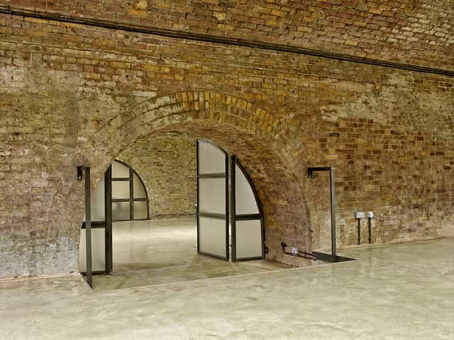 Versatile event space with exposed brick walls, ideal for gatherings and meetings.