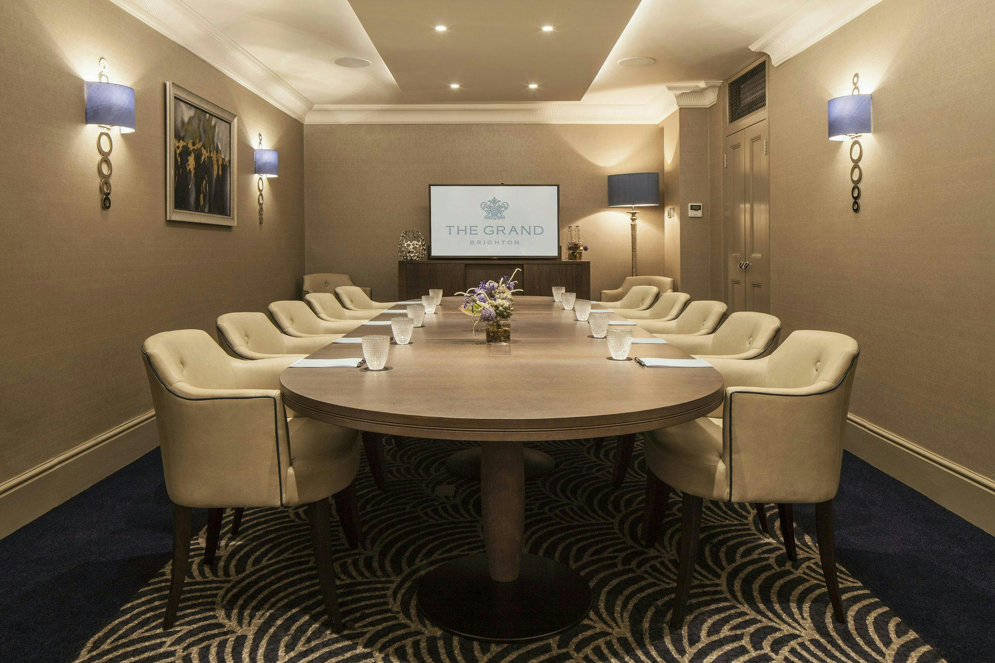 Empress Suite meeting room with round table, ideal for intimate corporate events.