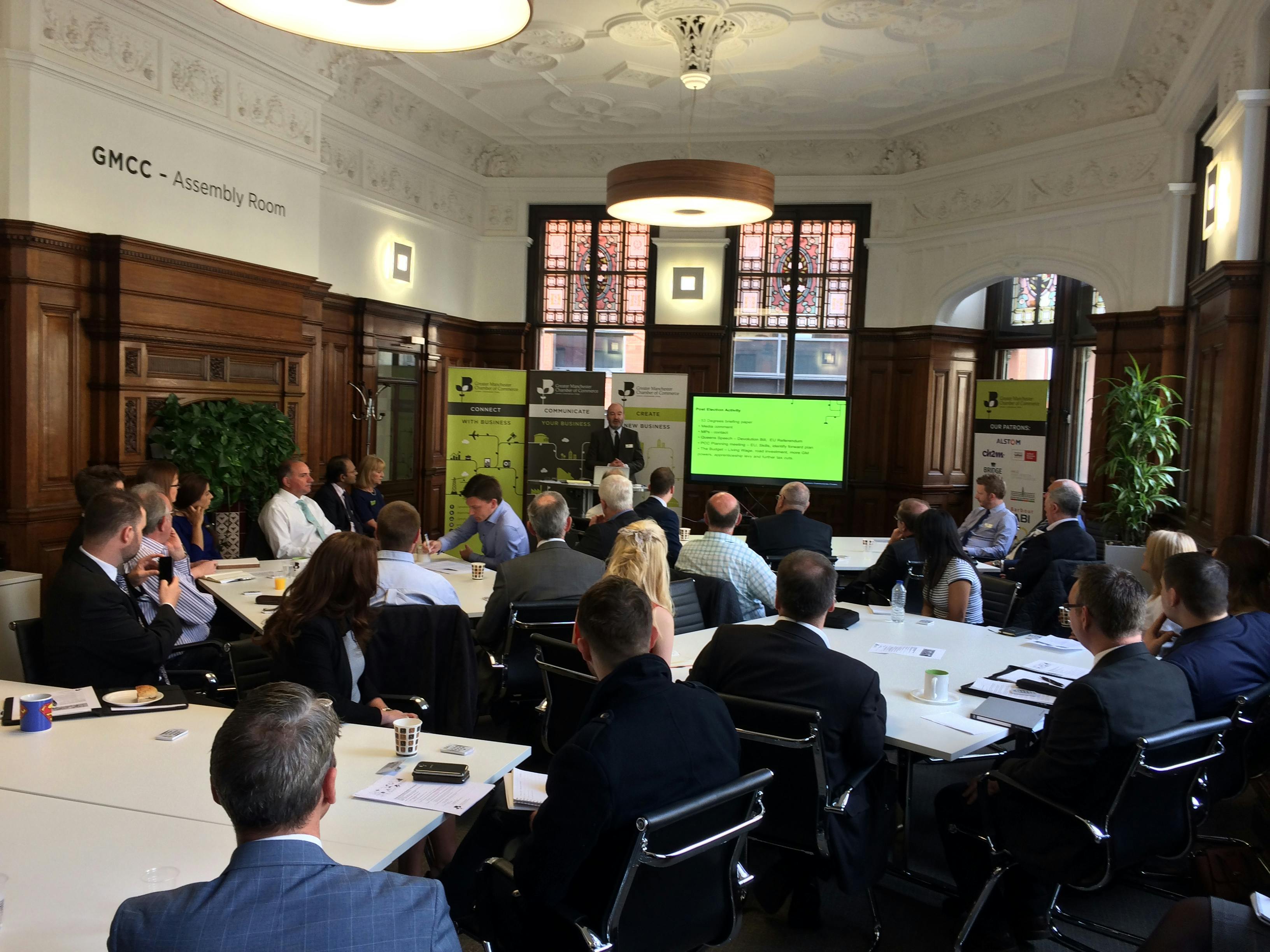 Board Room meeting with speaker, elegant architecture, corporate event, networking.