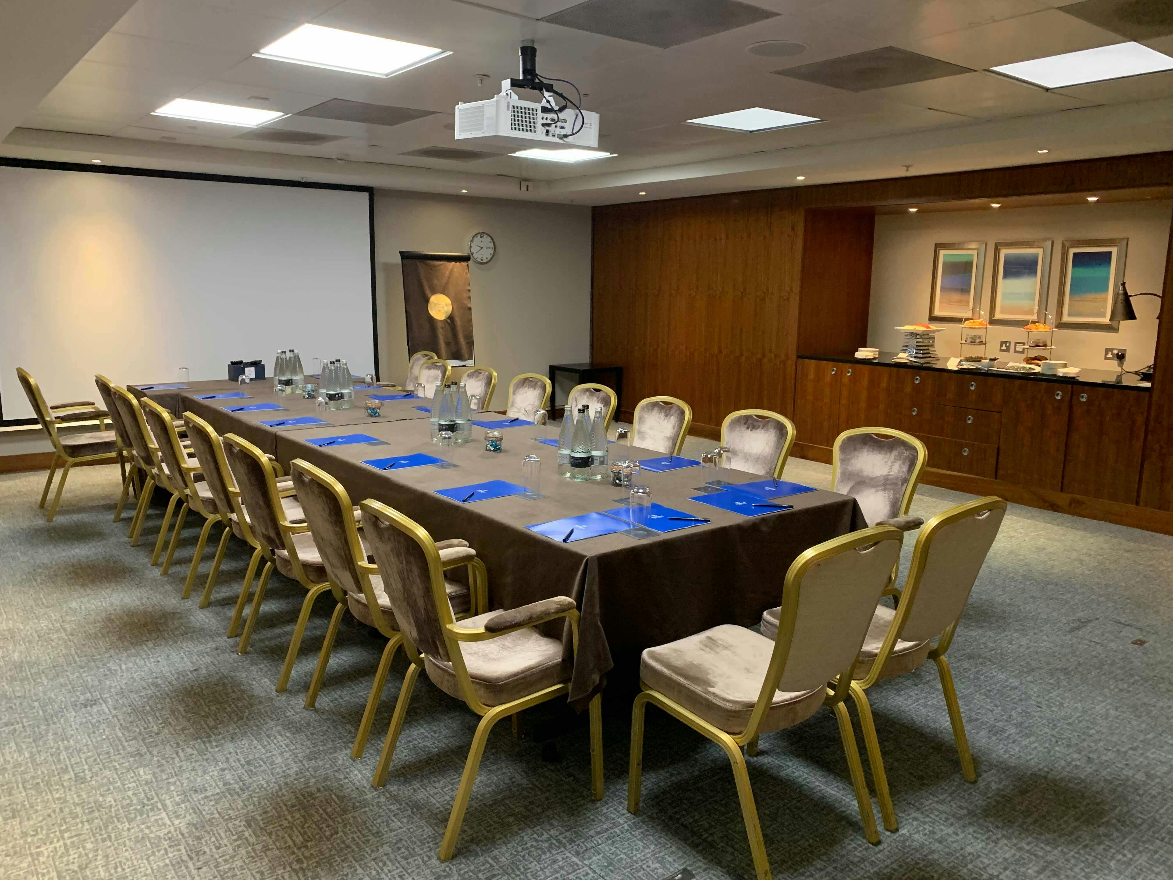 Mackenzie in a professional meeting room at The Waldorf Hilton, London, ready for collaboration.