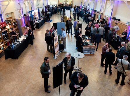 Prince Consort Rooms at HAC, bustling networking event with ambient lighting and booths. - Banner