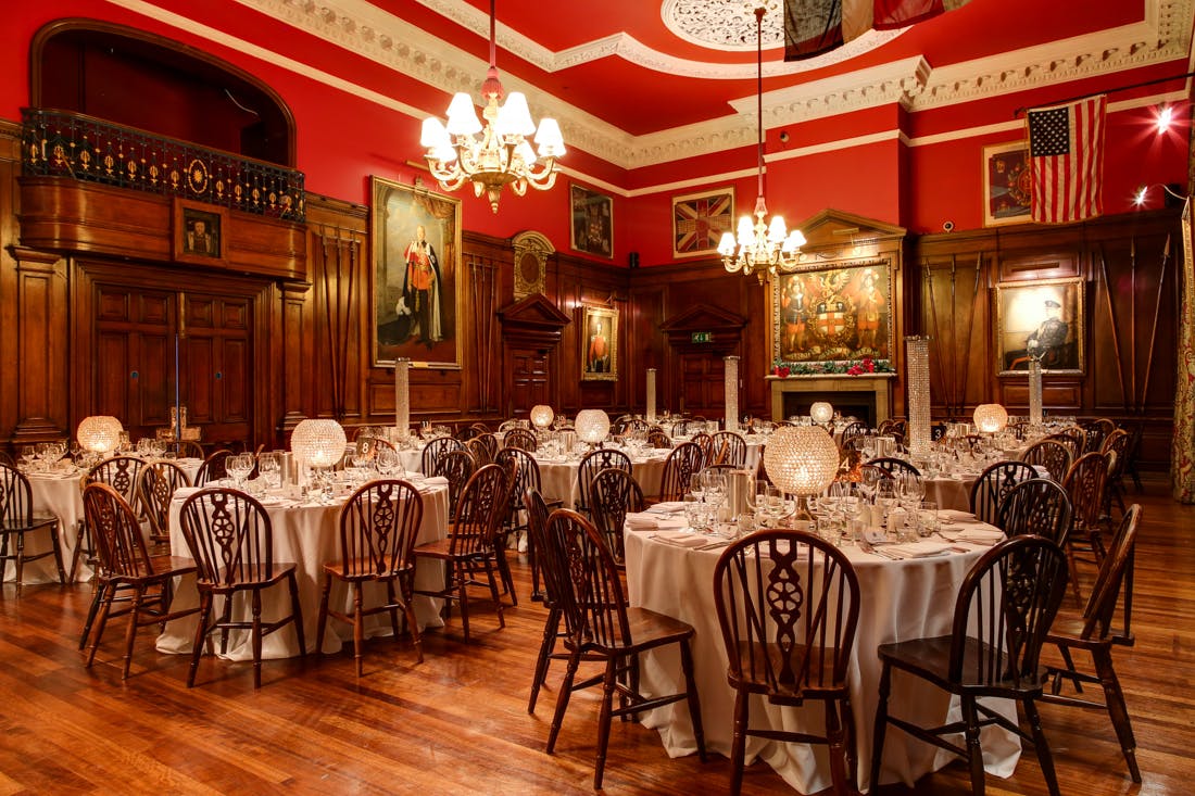 Elegant banquet hall with red walls, ideal for corporate dinners and upscale events.