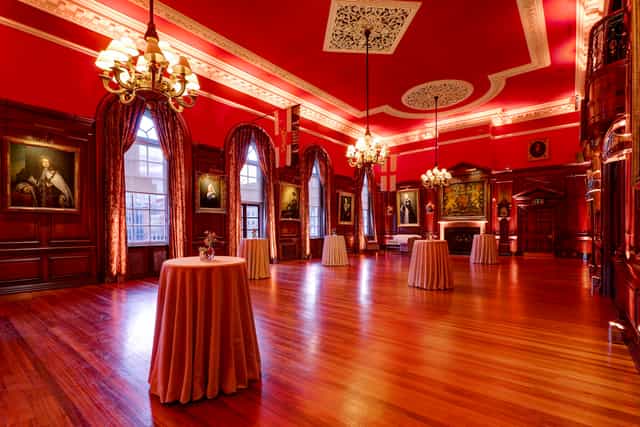 Elegant Long Room at HAC with red walls, ideal for receptions and gatherings.