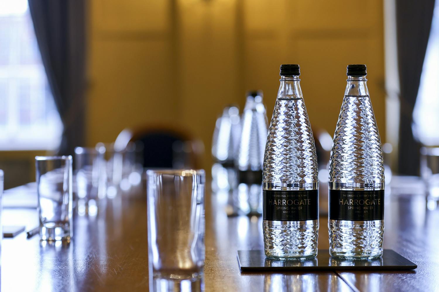Queen's Room at HAC: elegant meeting space with water bottles for professional events.