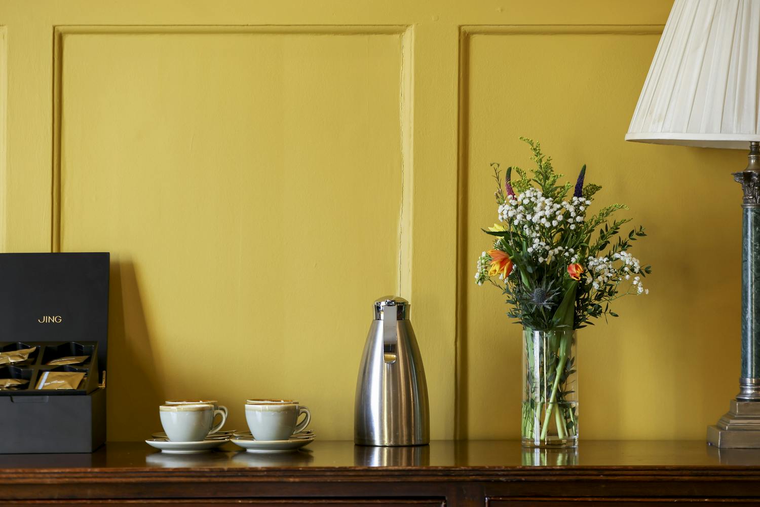Ante Room at HAC with vibrant yellow wall, ideal for meetings and events.