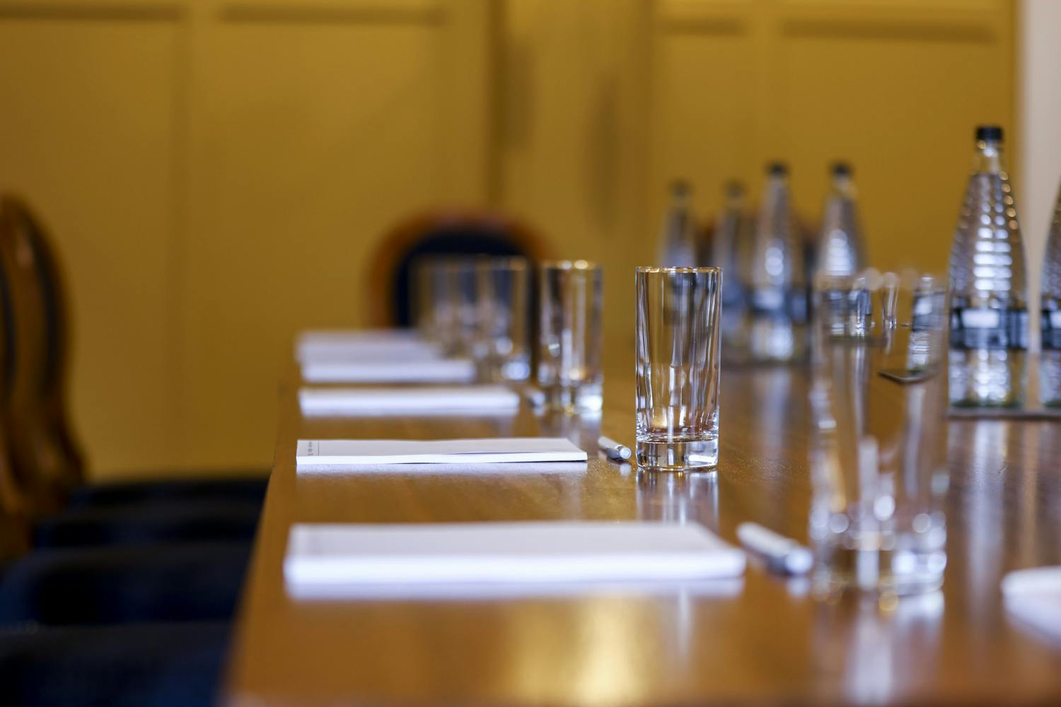 Ante Room at HAC: polished wooden table set for professional meetings and discussions.