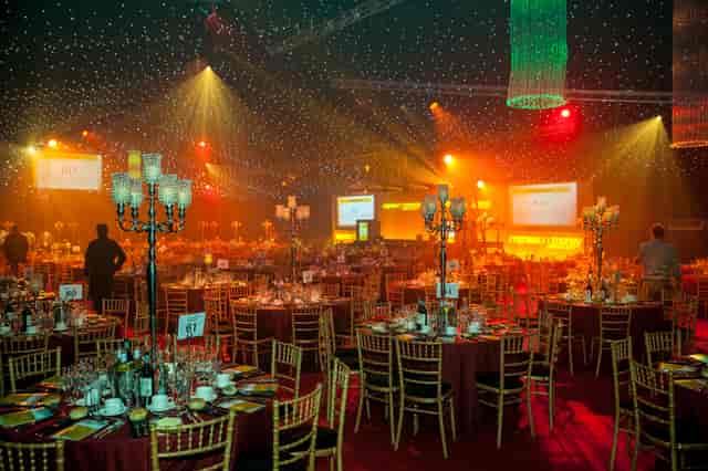 Elegant event space with round tables, perfect for corporate gatherings and gala dinners.