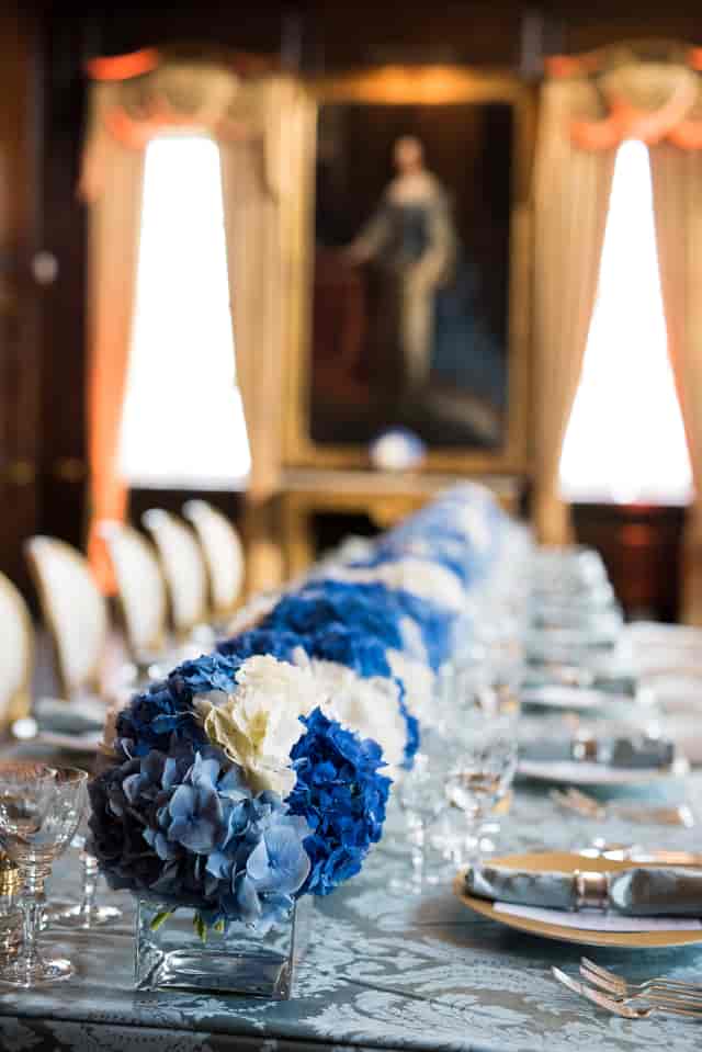 Elegant table setting with blue and white flowers at Royal Hospital Chelsea event.