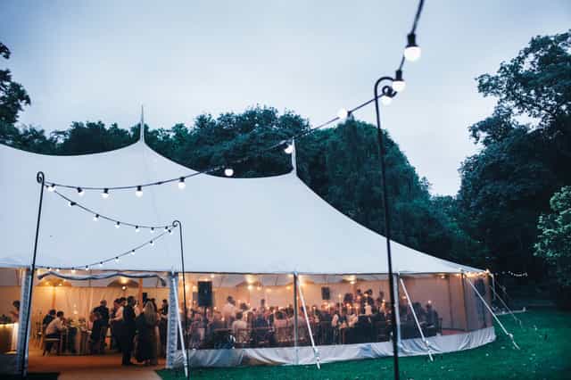 Outdoor event at Ranelagh Gardens, featuring a large tent and string lights for celebrations.