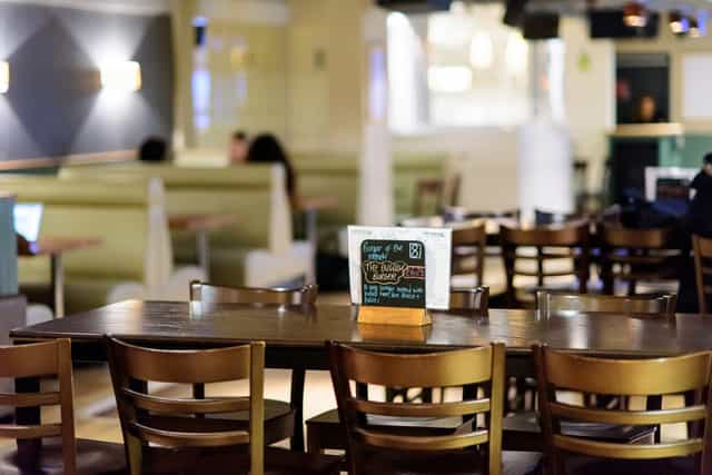 Versatile event space at Griff Inn Bar & Kitchen with wooden seating for networking events.